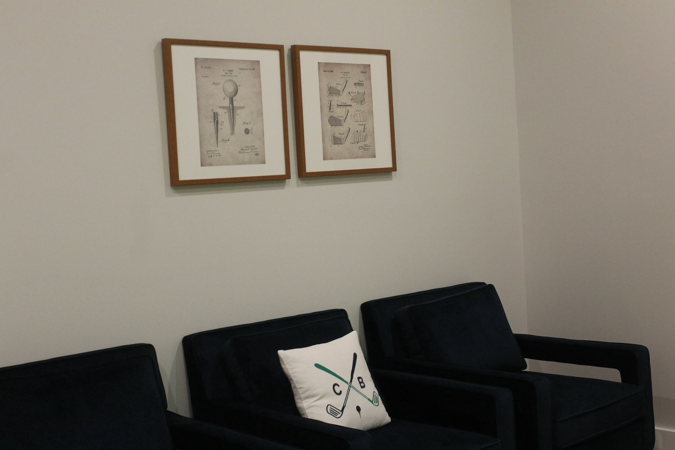 Lounge seating at Chip & Birdie&rsquo;s in Mountainside NJ with framed vintage golf patent drawings