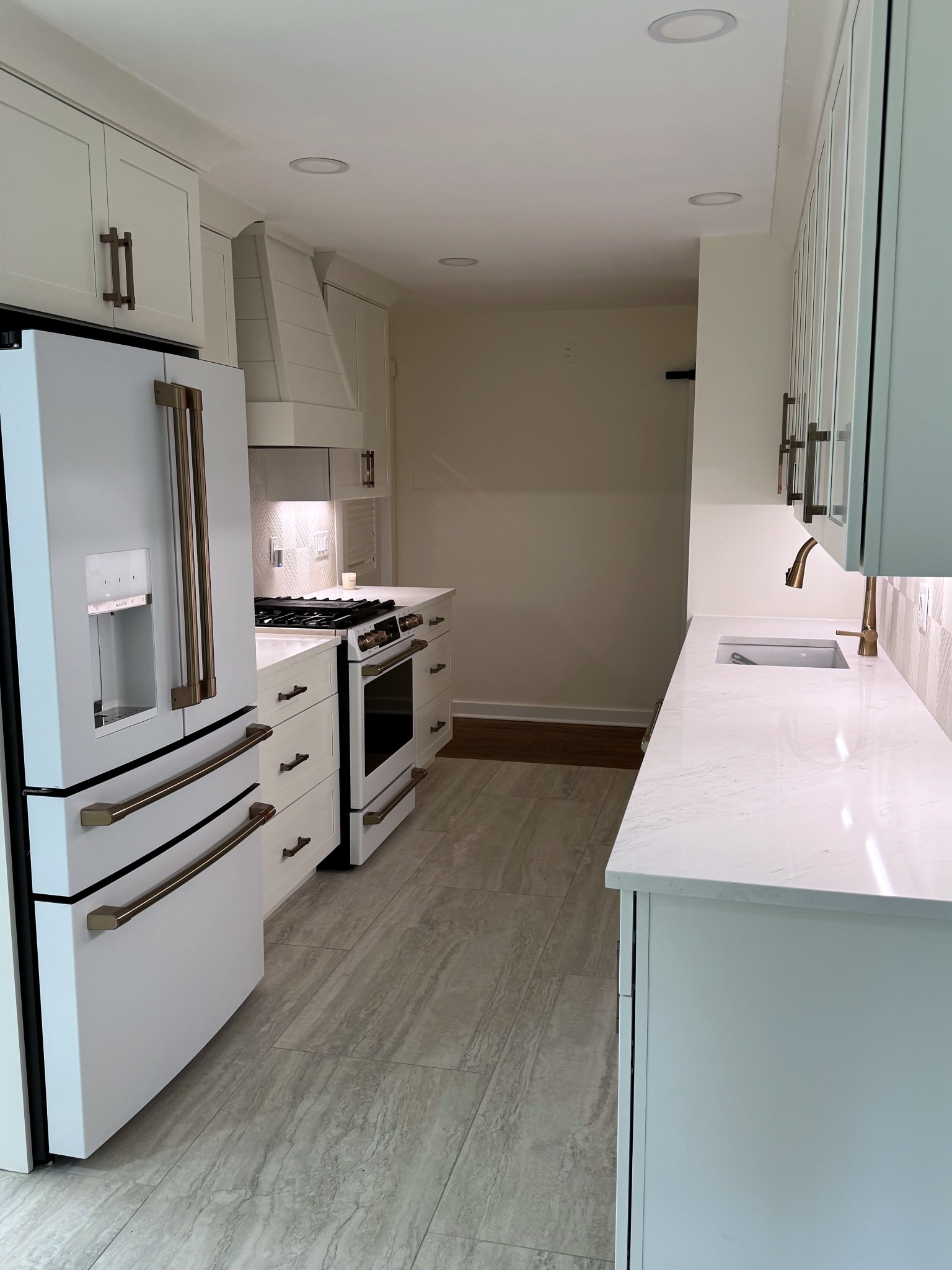 Wide view of the finished Montclair kitchen looking down the galley