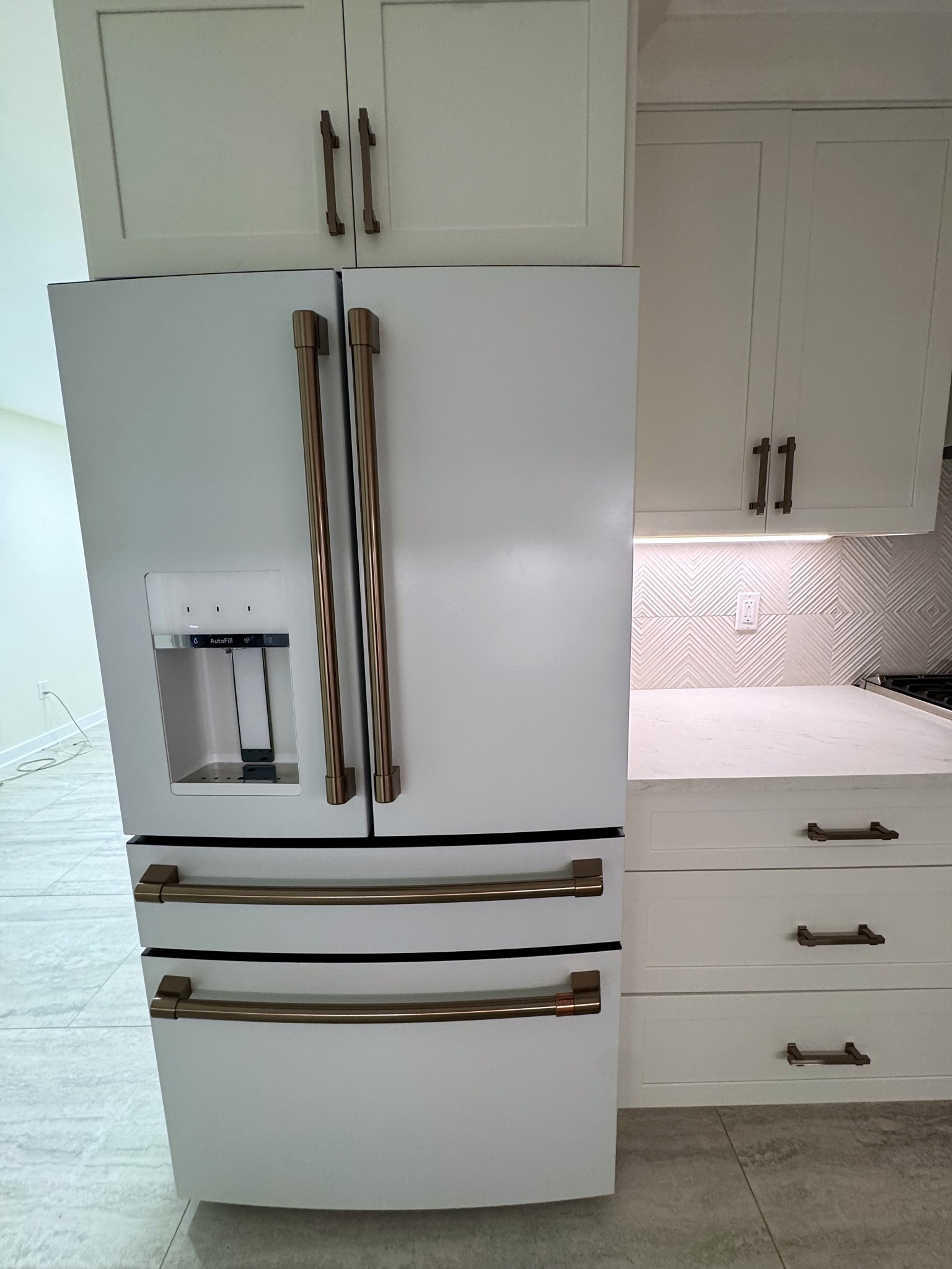 Refrigerator wall and tile detail in the finished Montclair kitchen